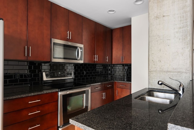 360 Nueces St Unit 2506, Austin, TX 78701 - kitchen featuring stainless steel appliances, a sink, tasteful backsplash, dark stone countertops, and recessed lighting