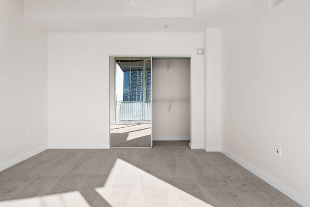 unfurnished bedroom with a closet and carpet flooring