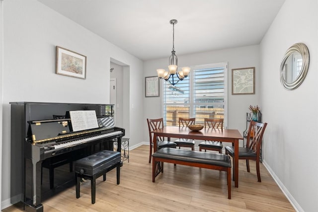 dining room with a chandelier and light hardwood / wood-style floors