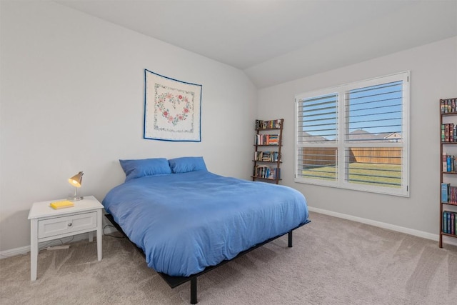 carpeted bedroom featuring lofted ceiling