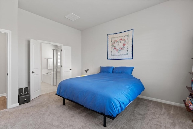 carpeted bedroom featuring ensuite bath