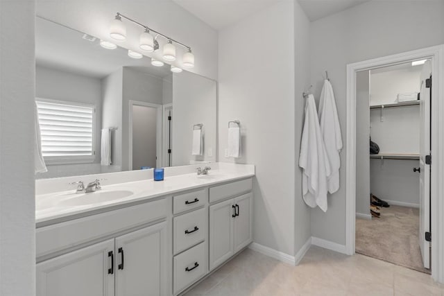 13104 Cerro Castellan Trce, Manor, TX 78653 - bathroom featuring double vanity, a walk in closet, and tile patterned floors