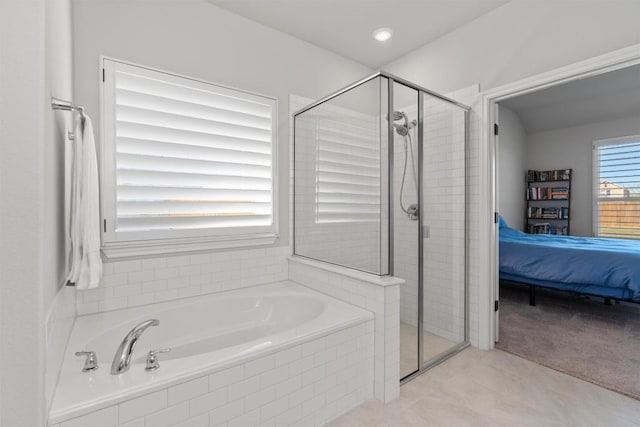 bathroom featuring tile patterned floors and shower with separate bathtub