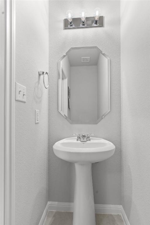 13104 Cerro Castellan Trce, Manor, TX 78653 - bathroom featuring a sink and baseboards