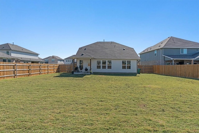 rear view of house with a yard and a patio