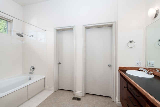 bathroom with washtub / shower combination, vanity, and tile patterned floors