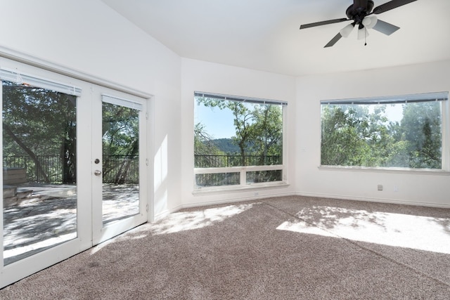 unfurnished sunroom with french doors, a ceiling fan, and a healthy amount of sunlight