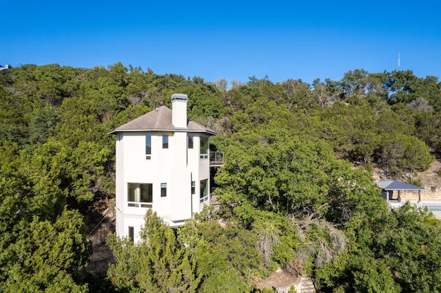 birds eye view of property with a wooded view