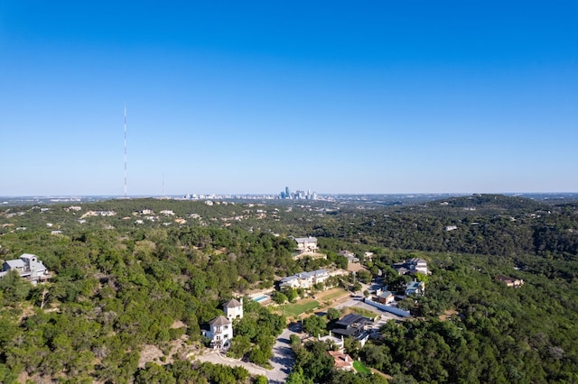 drone / aerial view featuring a wooded view