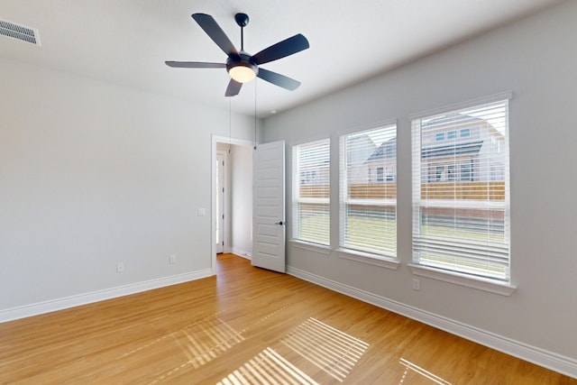 spare room with ceiling fan, light hardwood / wood-style flooring, and a healthy amount of sunlight