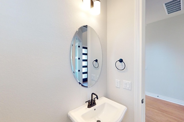 bathroom with sink and wood-type flooring