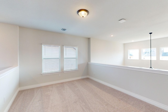 empty room featuring light colored carpet