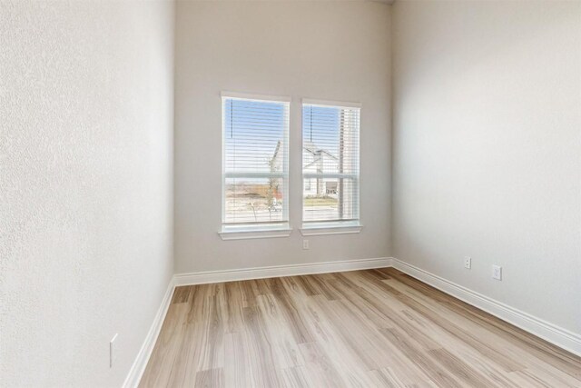 empty room with light hardwood / wood-style flooring