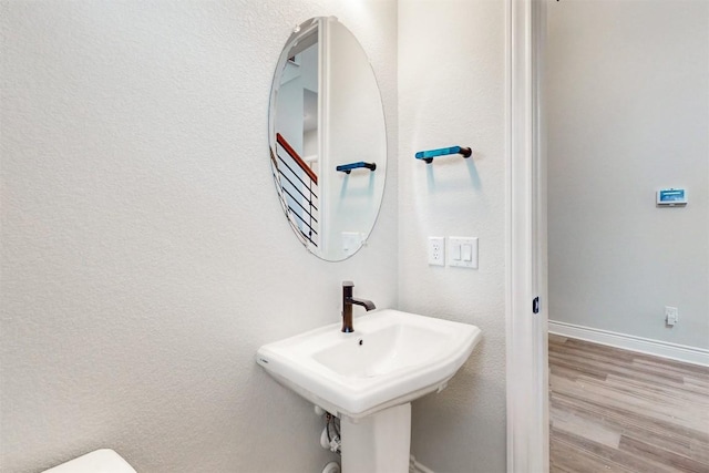 bathroom with hardwood / wood-style floors and sink