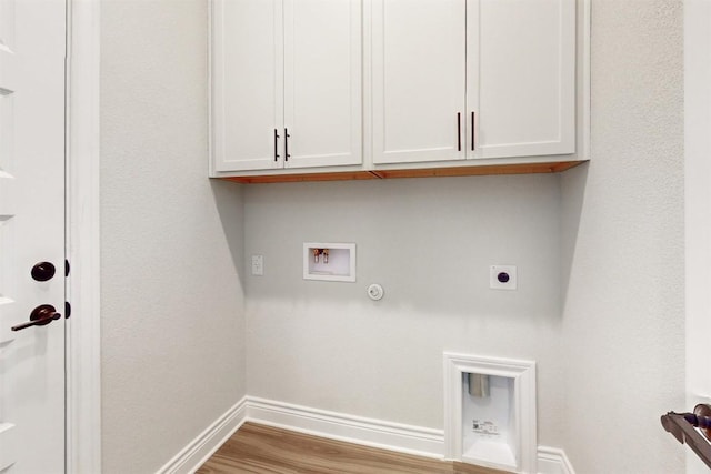 clothes washing area with cabinets, hookup for a washing machine, gas dryer hookup, electric dryer hookup, and light hardwood / wood-style flooring