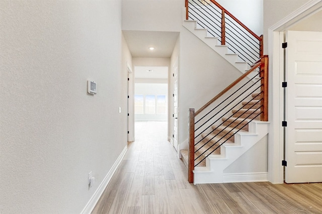 stairway with hardwood / wood-style flooring