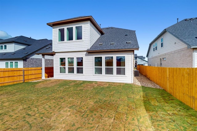 back of property with a yard and central AC unit