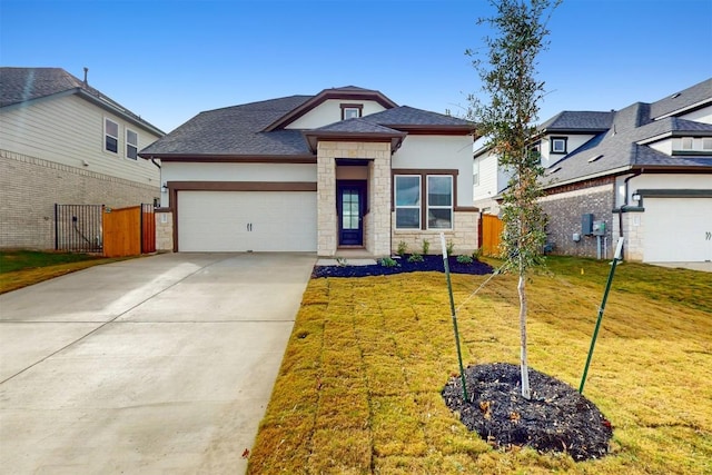 view of front of property with a garage and a front yard