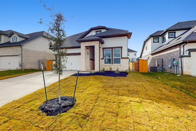 view of front of home featuring a garage and a front lawn