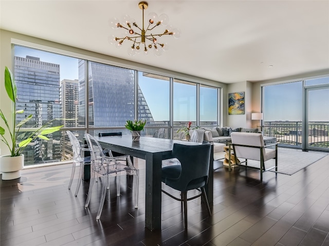 dining area with an inviting chandelier, dark wood-type flooring, and expansive windows