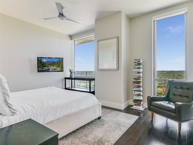 bedroom with ceiling fan and dark wood-type flooring