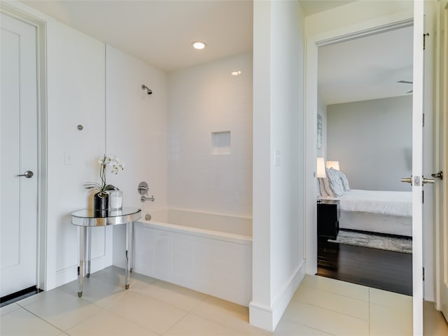 bathroom featuring tiled shower / bath combo and tile patterned floors