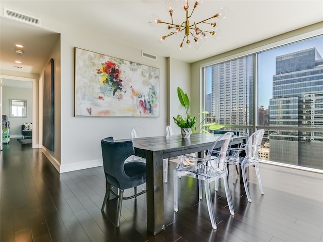 dining room featuring an inviting chandelier and dark hardwood / wood-style flooring