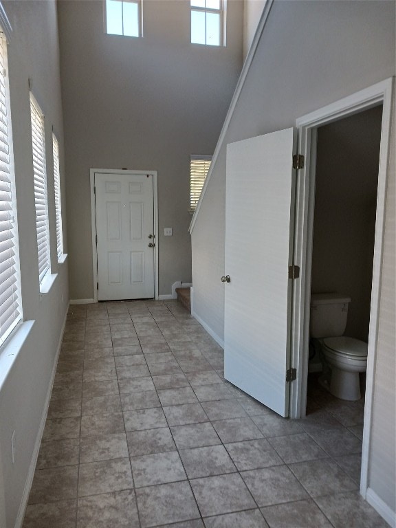 tiled entryway featuring a high ceiling