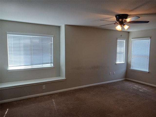 carpeted empty room featuring plenty of natural light and ceiling fan