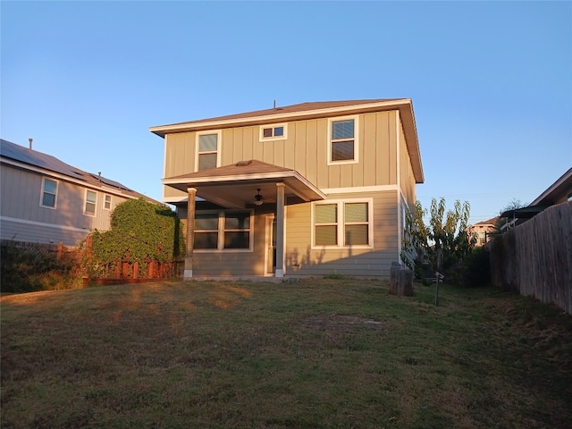 rear view of property featuring a yard