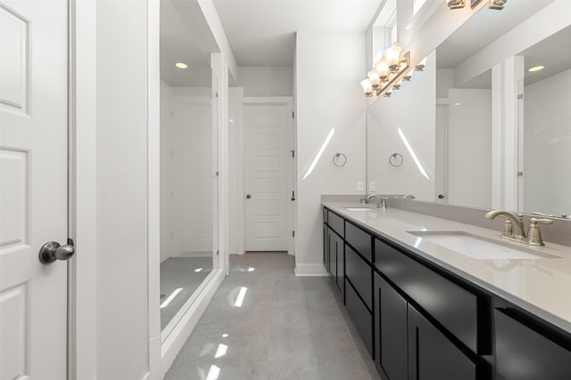 bathroom with vanity, tile patterned floors, and tiled shower