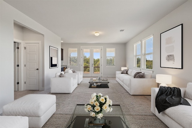 living room featuring french doors and carpet