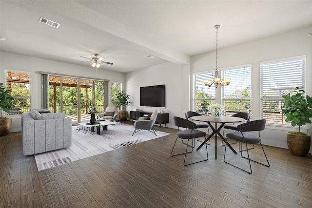 dining area featuring ceiling fan with notable chandelier, plenty of natural light, and wood-type flooring