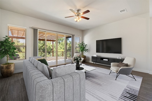 living room featuring dark hardwood / wood-style floors and ceiling fan