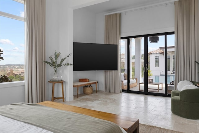 bedroom with access to exterior and stone tile floors