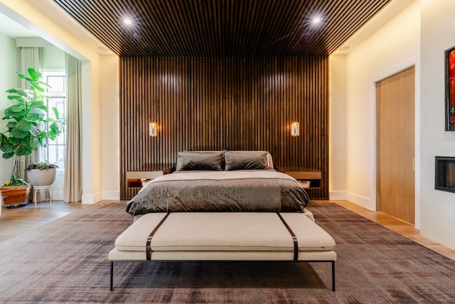 bedroom with a fireplace and recessed lighting