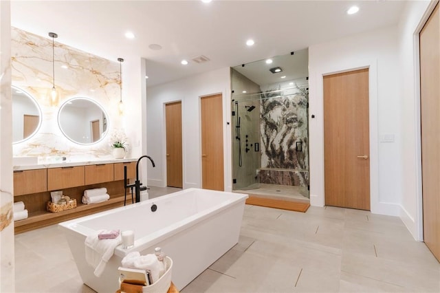 bathroom with a freestanding tub, recessed lighting, visible vents, vanity, and a stall shower