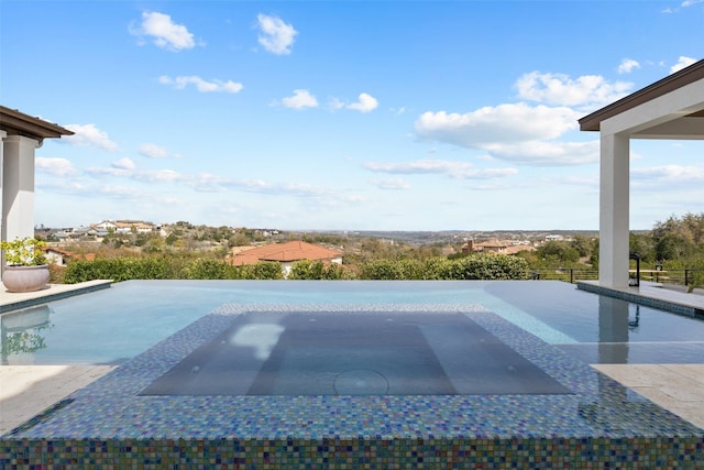 view of pool with an in ground hot tub