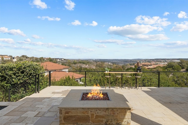 view of patio with a fire pit