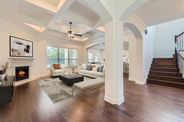 living room featuring crown molding, ceiling fan, beam ceiling, dark hardwood / wood-style floors, and coffered ceiling