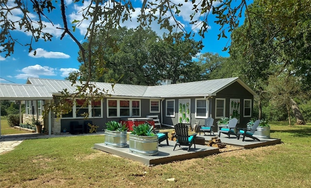 back of house featuring a lawn and a deck