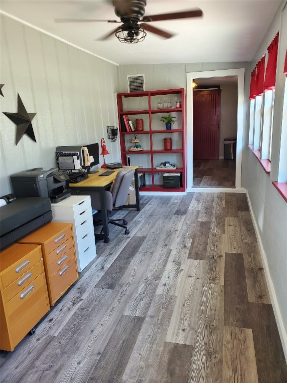 unfurnished office featuring wood-type flooring and ceiling fan