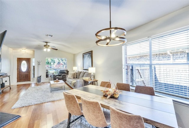 4316 Campo Verde Dr, Austin, TX 78749 - dining space with light wood-style floors, a chandelier, vaulted ceiling, and a ceiling fan