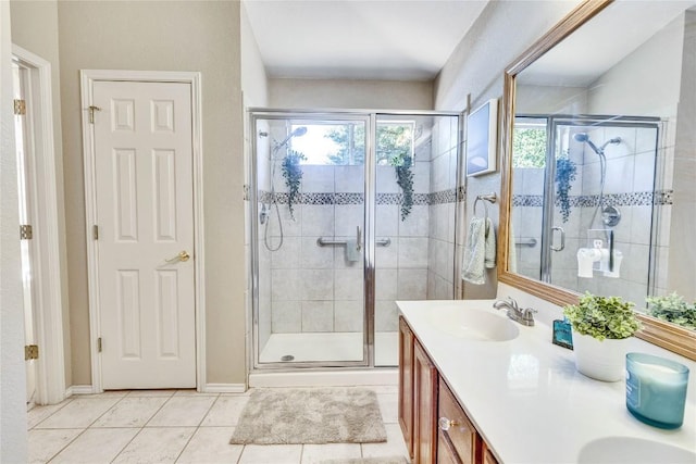 4316 Campo Verde Dr, Austin, TX 78749 - full bathroom with a shower stall, double vanity, tile patterned flooring, and baseboards