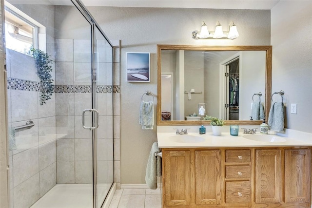 4316 Campo Verde Dr, Austin, TX 78749 - full bathroom with a stall shower, double vanity, tile patterned floors, and baseboards