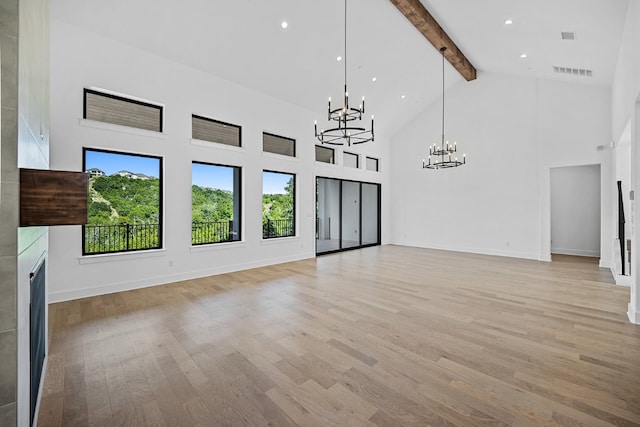 unfurnished living room featuring high vaulted ceiling, a chandelier, light hardwood / wood-style floors, and beamed ceiling