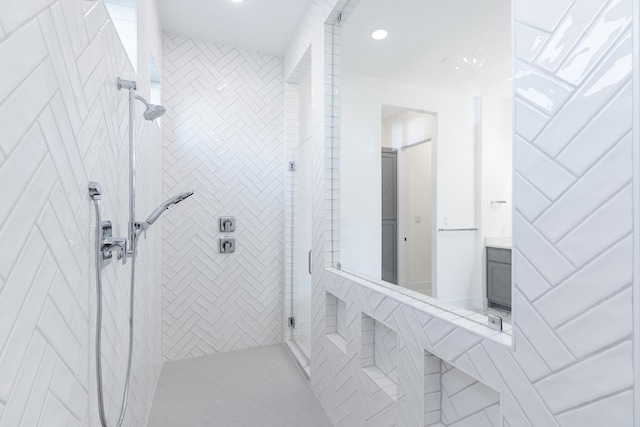 bathroom featuring vanity and a tile shower