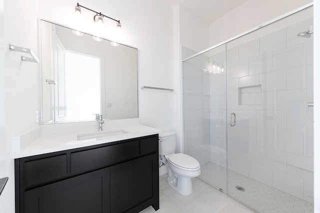 bathroom with vanity, toilet, a shower with door, and tile patterned floors