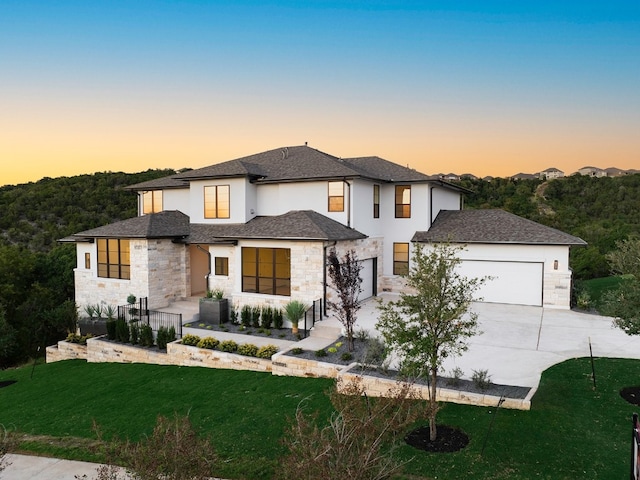 view of front of property featuring a garage and a yard