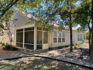 rear view of house with a sunroom